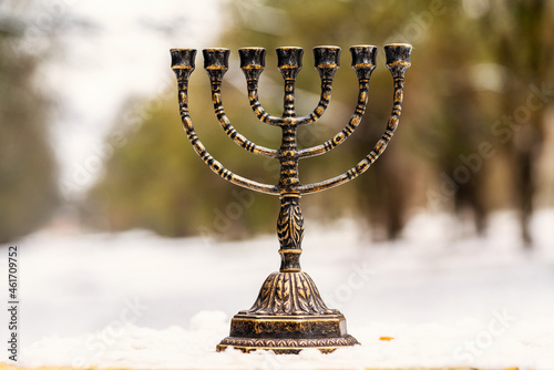 Obraz na płótnie menorah stands in the snow against the background of nature w salonie