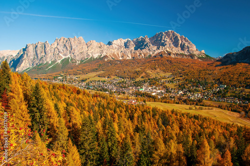 Scenic view on Cortina d'Ampezzo town in mountain valley at sunny autumn day, Dolomite Alps, Italy