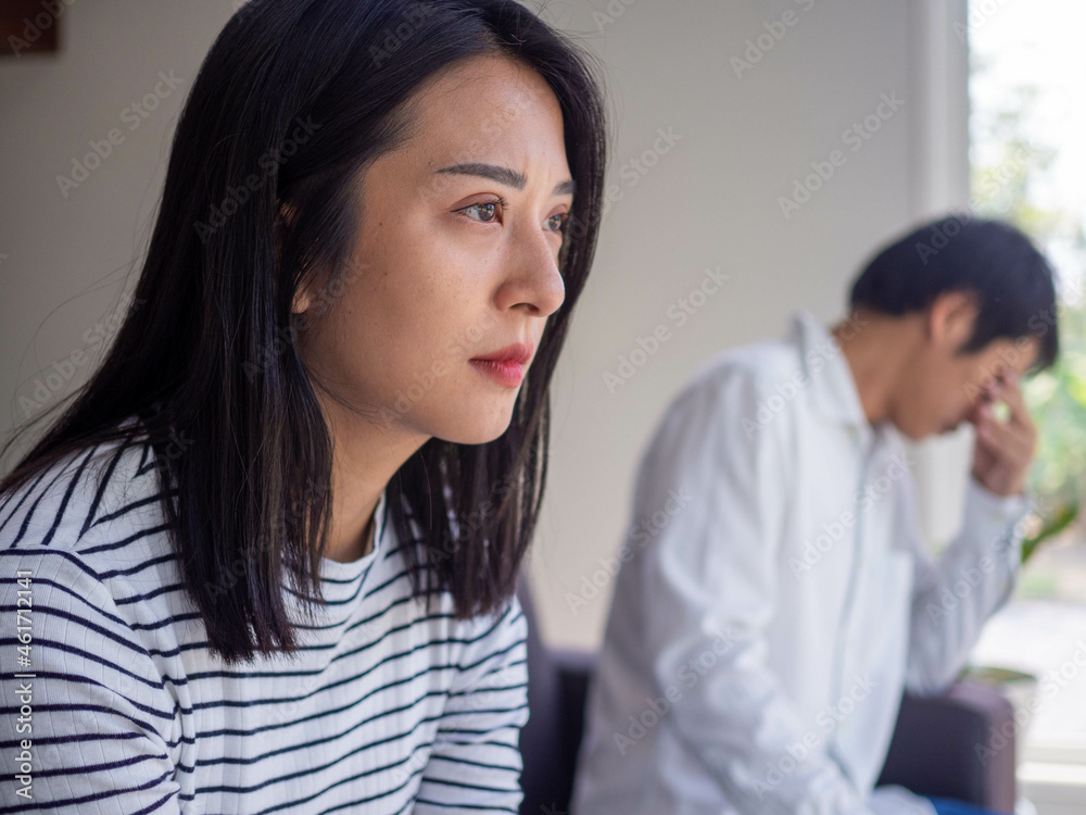 Asian women are disappointed and saddened after an argument with their husband. Asian couples are having family problems resulting in divorce. Love problem Asian women are disappointed and saddened after an argument with their husband. Asian couples are having family problems resulting in divorce. Love problem