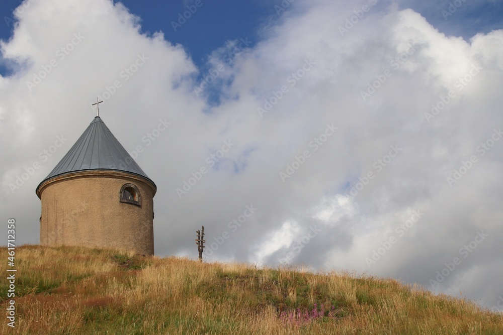 A little chapel with clouds at the top of the hill Mednik near Medenec, Czech republic
