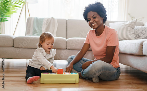 nursery babysitter with baby play with toys photo