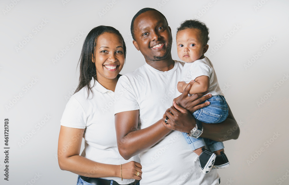 Young African American family in the studio with baby toddler son Young African American family in the studio with baby toddler son