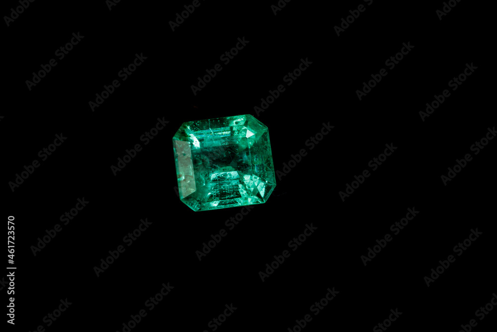 Macro mineral Emerald gemstone faceted on black background Macro mineral Emerald gemstone faceted on black background