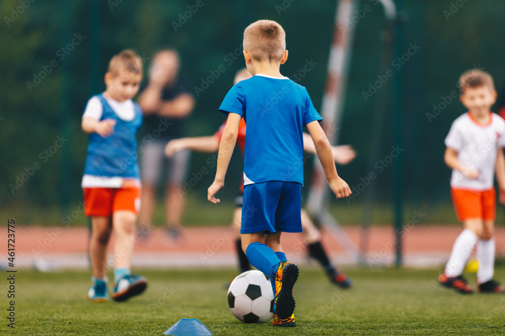 Happy School Kids Playing Football Game on School Field. Boys Kicking Soccer Ball on Artificial Grass Field