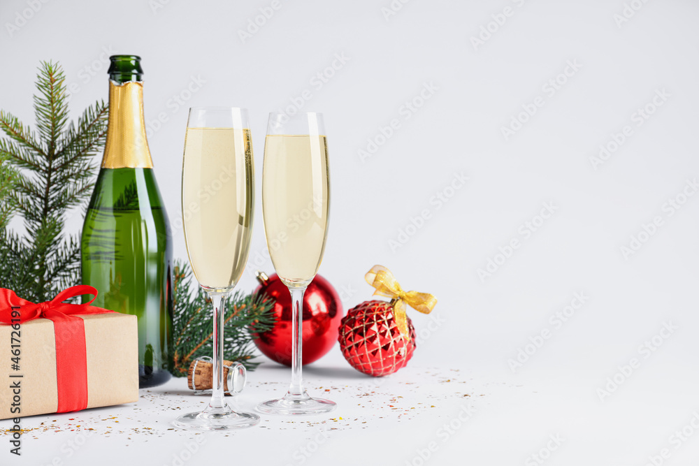 Happy New Year! Bottle of sparkling wine, glasses and festive decor on white background, space for text - obrazy, fototapety, plakaty 
