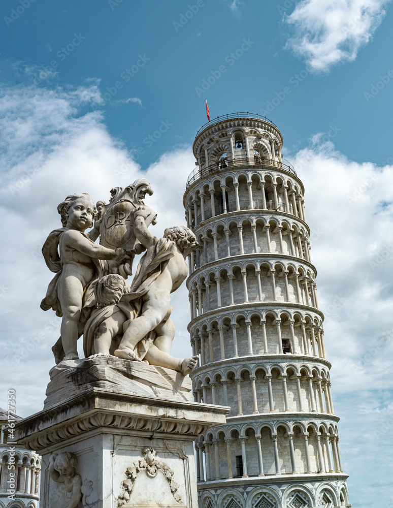 Monument with cherubs with background of the tower of Pisa in Italy 
