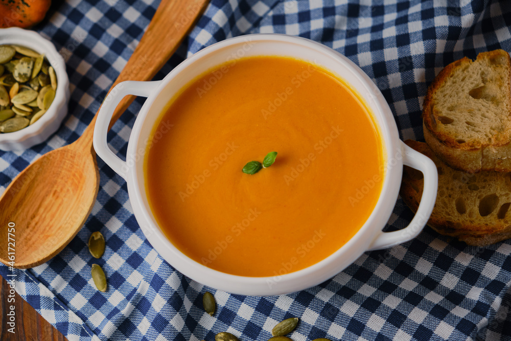 Homemade pumpkin soup with cream and basil Homemade pumpkin soup with cream and basil