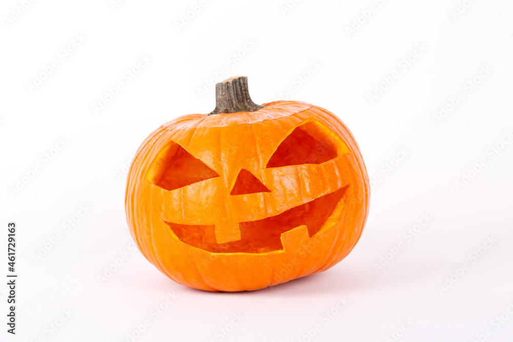 Orange pumpkin carved into creepy and funny Jack o Lantern isolated on white background. All hallows night. Copy space, close up, top view. Halloween party decoration. Trick or treat concept. Orange pumpkin carved into creepy and funny Jack o Lantern isolated on white background. All hallows night. Copy space, close up, top view. Halloween party decoration. Trick or treat concept.