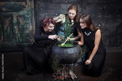 Young beautiful witches preparing a potion for Halloween 