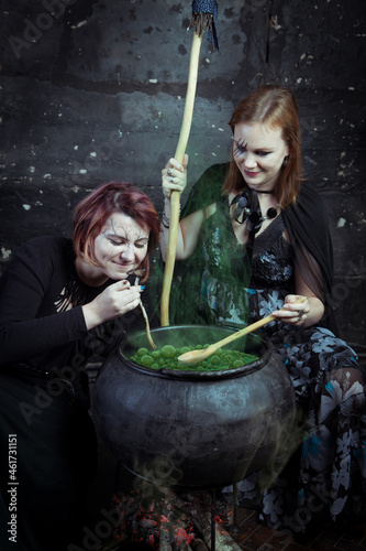 Young beautiful witches preparing a potion for Halloween 