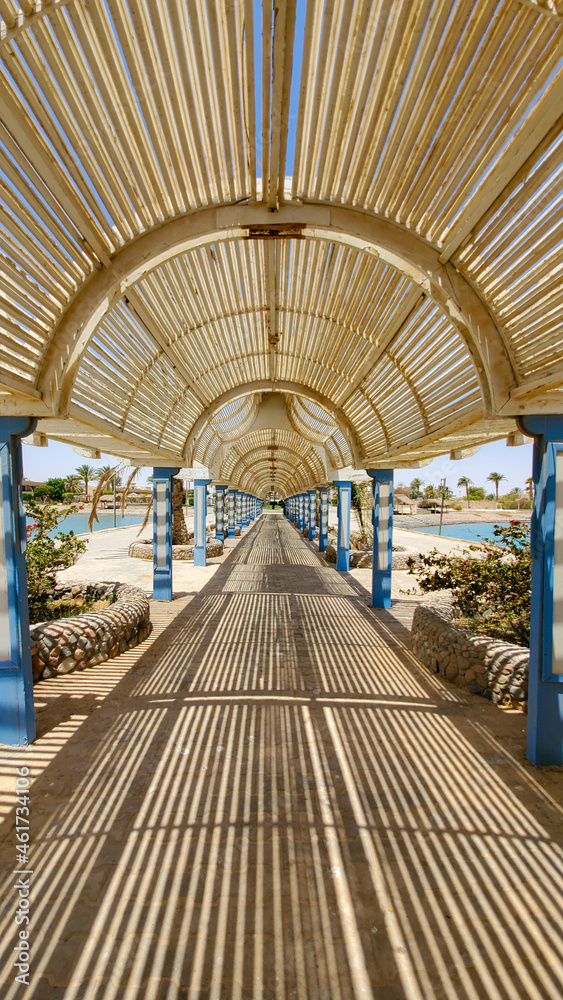 An unusual transition from the hotel to the beach in close-up, protection from the sun, a corridor with a canopy from sunlight, a safe transition