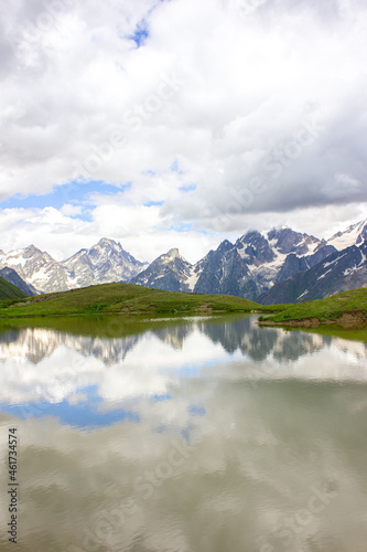 The Caucasus mountains and clouds are reflected in the mountain Koruldi lakes