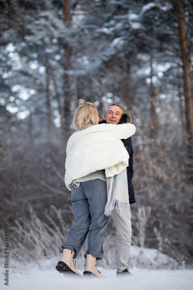 adult man and woman hugging on the street in winter adult man and woman hugging on the street in winter