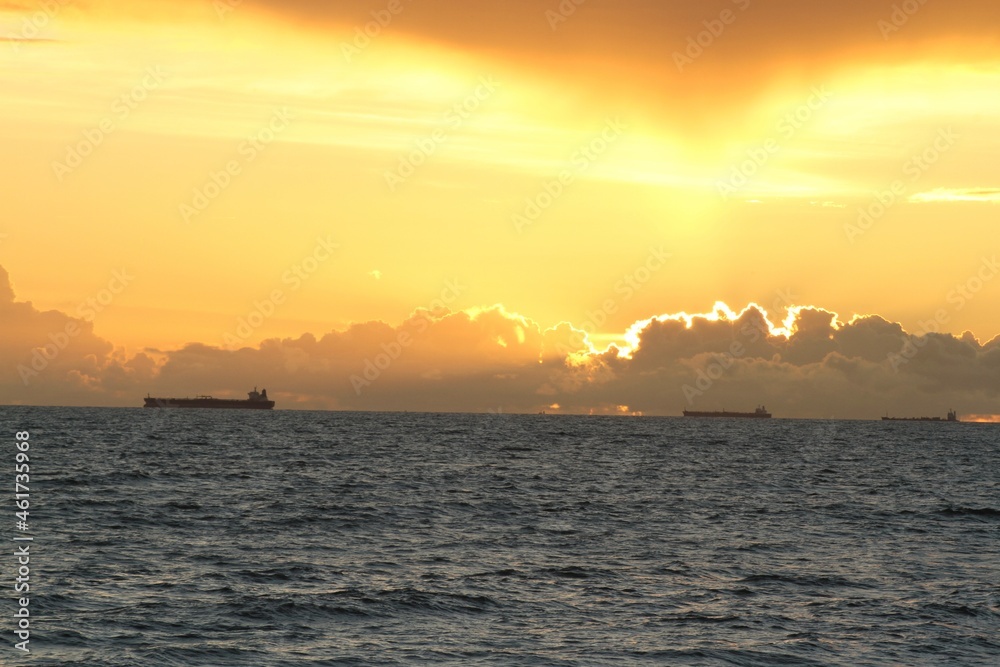ships at the horizon during golden hour
