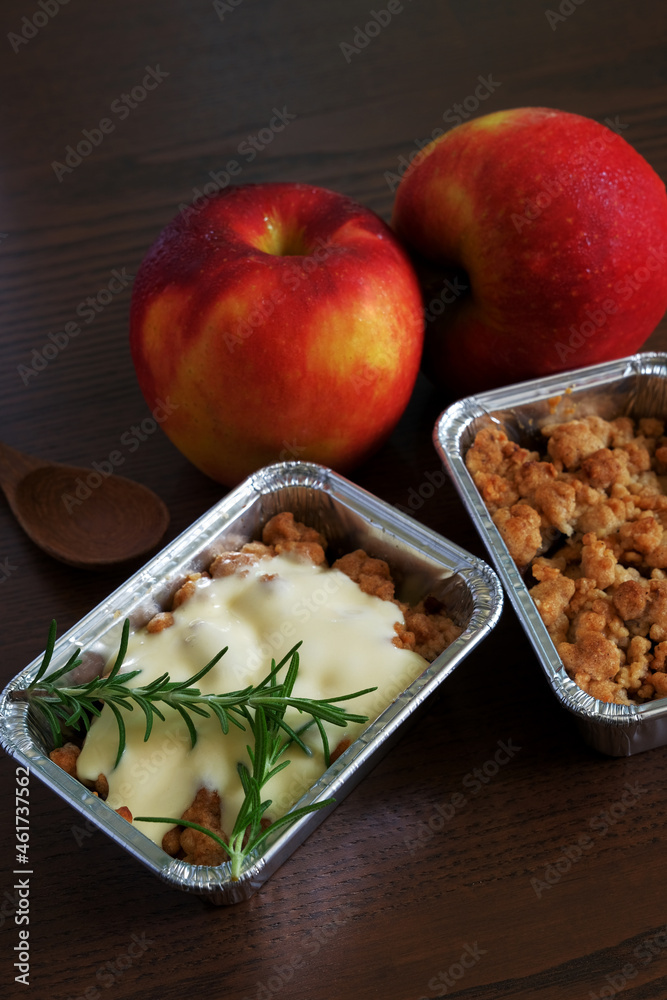 Apple Crumble Cake with apples on a wooden table Apple Crumble Cake with apples on a wooden table