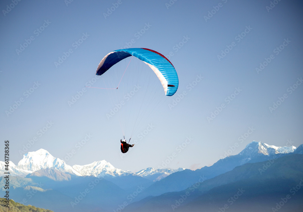 glider paragliding over snowy mountain peaks flying adrenaline and freedom concept glider paragliding over snowy mountain peaks flying adrenaline and freedom concept