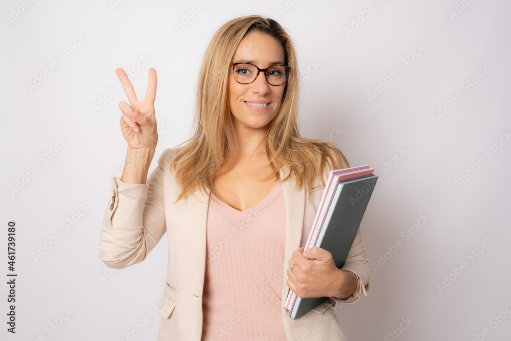 Cheerful young business woman isolated on white background studio with victory sign. Achievement career wealth business concept. Cheerful young business woman isolated on white background studio with victory sign. Achievement career wealth business concept.