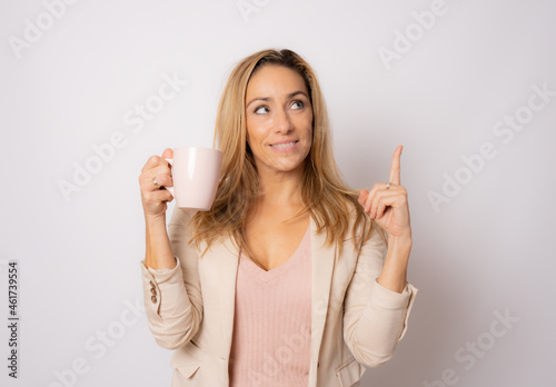 happy smile business woman hold cup of coffee pointing finger up isolated over white background