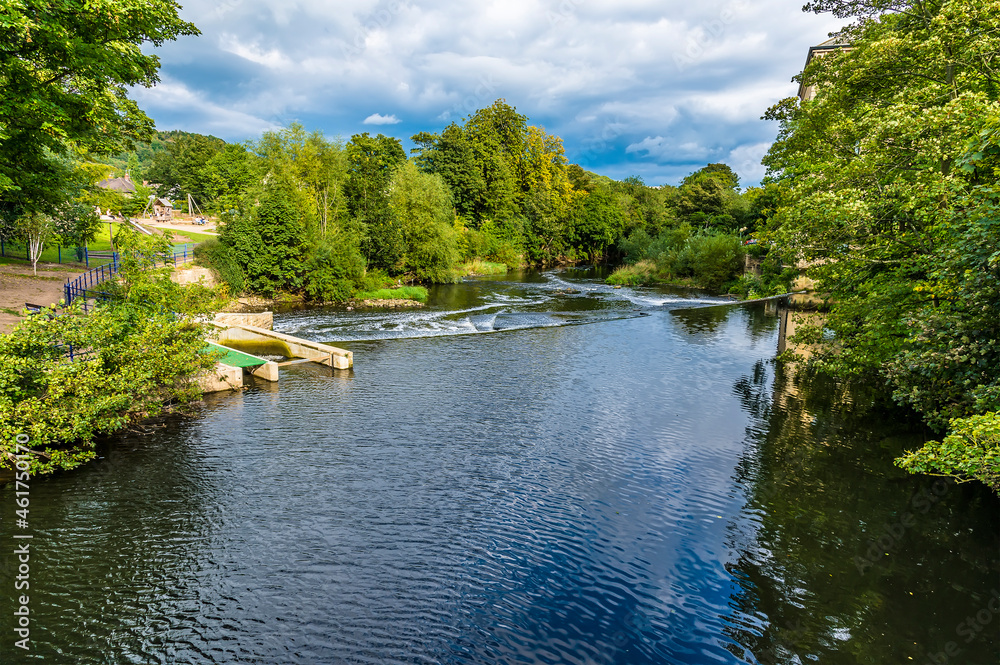 A view down the River Aire on the outskirts of the model village of Saltaire, Yorkshire, UK in summertime A view down the River Aire on the outskirts of the model village of Saltaire, Yorkshire, UK in summertime