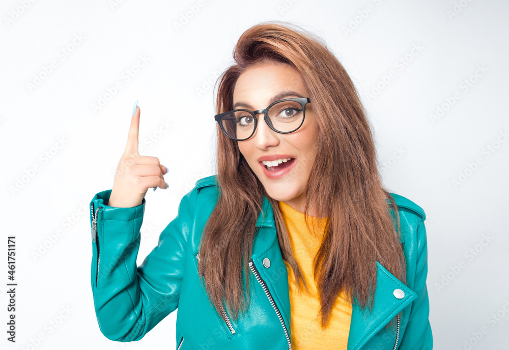 Idea gesturing. Surprised young woman pointing up with his finger, isolated on white background. Amazed girl with open mouth Idea gesturing. Surprised young woman pointing up with his finger, isolated on white background. Amazed girl with open mouth