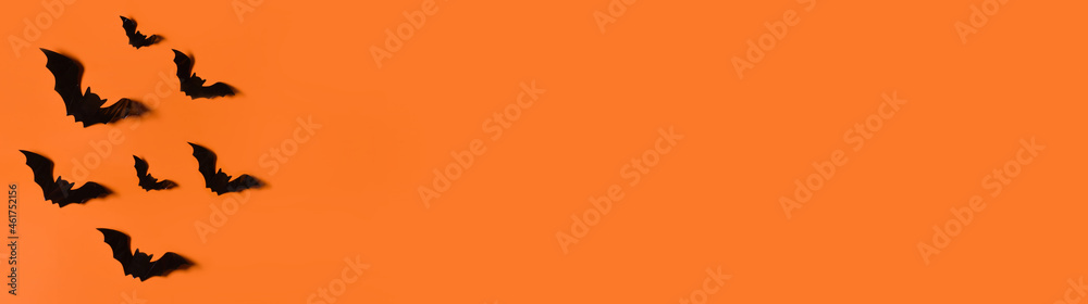 Halloween background. Bats on an orange background.Trick or treat. Banner. Copy space for text Halloween background. Bats on an orange background.Trick or treat. Banner. Copy space for text