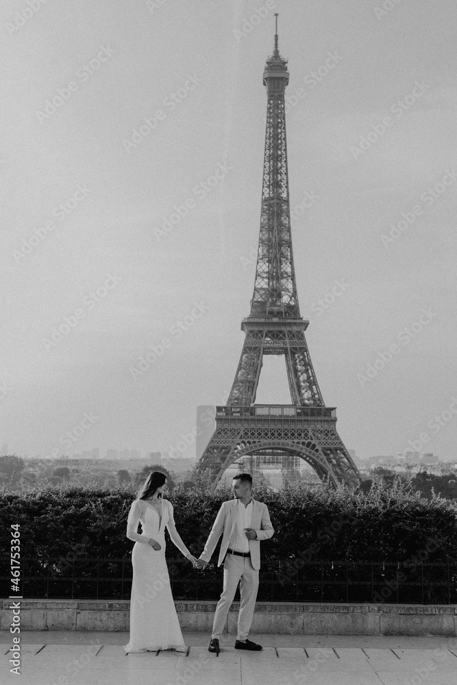 Wedding couple holding hands. Black and white photo.