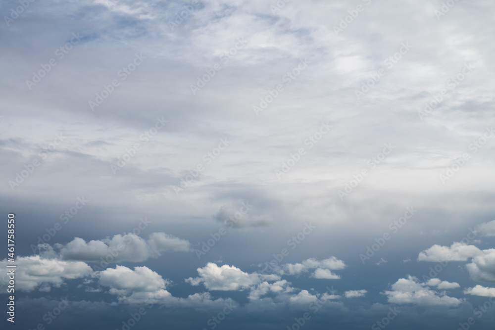 Replacement sky background or backdrop with beautiful fluffy white cumulus clouds below and altostratus clouds above with a dark blue sky showing through beyond.