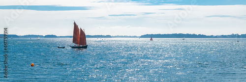 A sinagot, old boat at the Ile-aux-Moines island, with red sails, traditional boat in the Morbihan gulf, Brittany photo