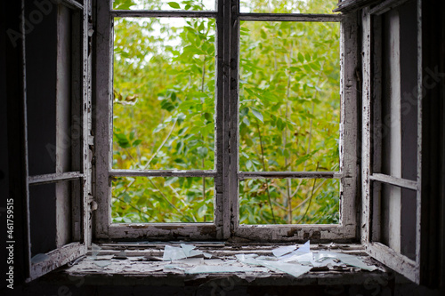 open window with old wooden frame. old window. finely broken glass. old house  retro. cracked window frame. cracked old paint  pieces of glass. space for text. large pieces of glass. close-up