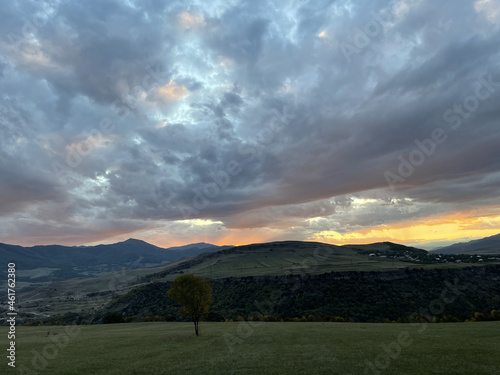 Landscape of farm fields and hills under a cloudy sky in the evening in Dsegh, Lori, Armenia photo