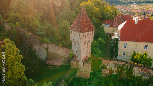 Aerial photography of a medieval tower fortification called Turnul Cositorarilor, located in medieval town of Sighisoara, Romania. Aerial view of a medieval defensive tower. photo