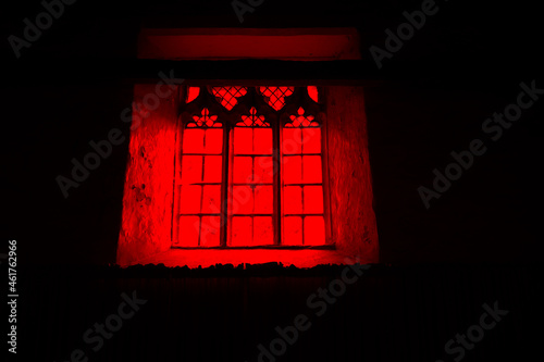 A horror concept of a spooky church window. With a red, black moody edit.