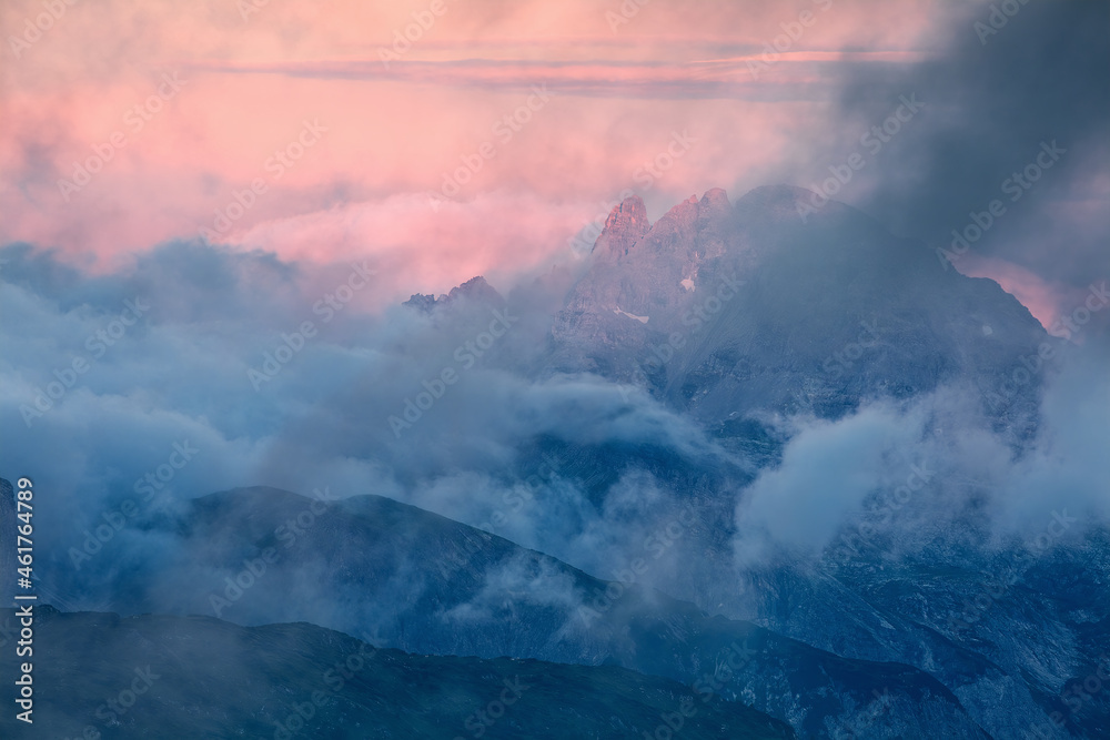 dramatic foggy purple sunrise in Alps