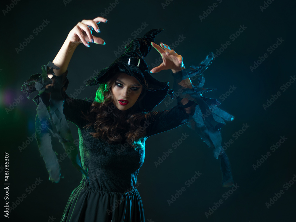 beautiful witch with a hat make spell. Halloween party, witches ' Sabbath.
