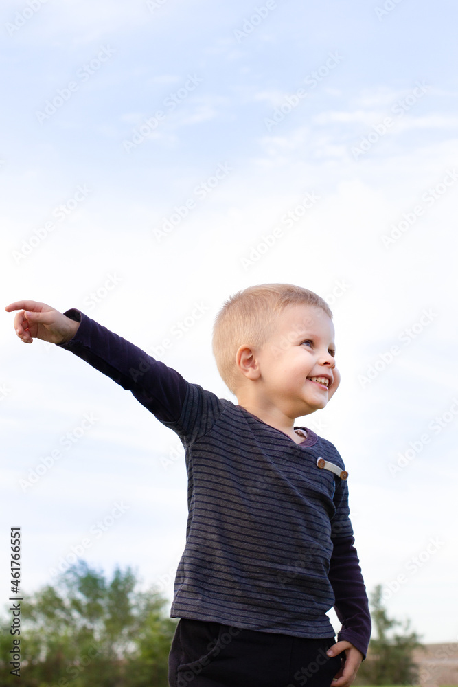 Active little boy pointing his finger and looking up while playing in the playground,Toddler playing outside with colorful of Autumn leaves in blurry background, Children activities outdoors concept Active little boy pointing his finger and looking up while playing in the playground,Toddler playing outside with colorful of Autumn leaves in blurry background, Children activities outdoors concept
