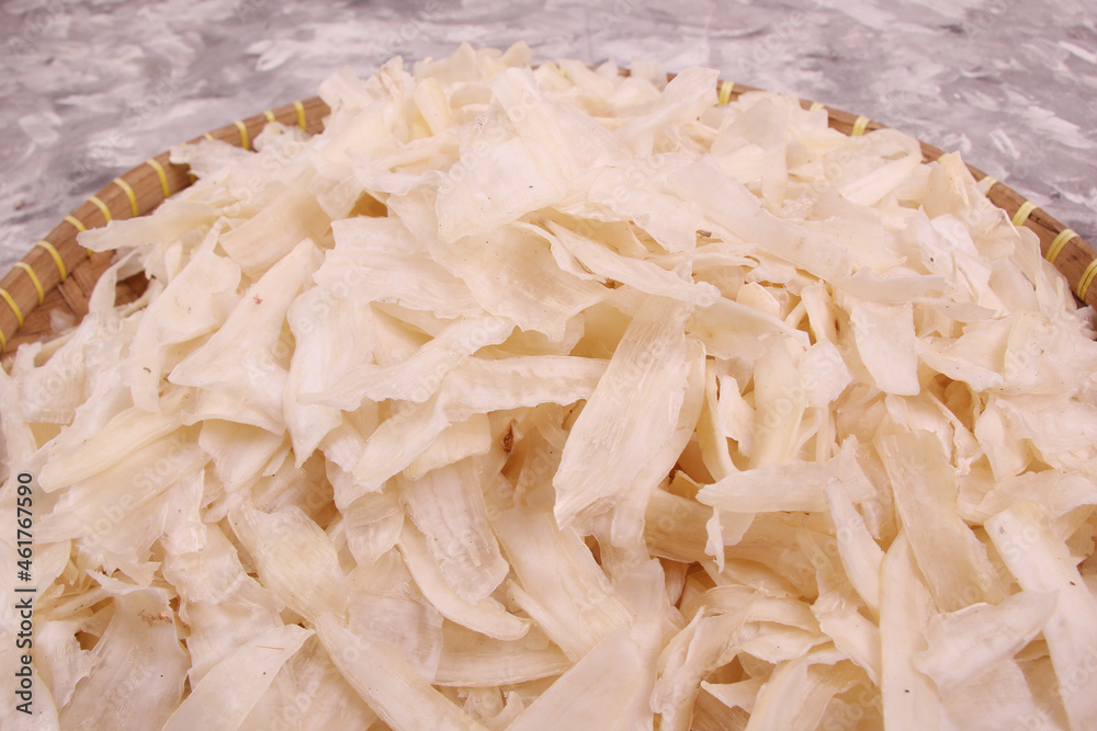 closeup, Mangleng is chips made from cassava slices. cassava pieces are stacked on a bamboo winnowing. Indonesian dry food