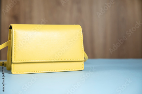 fashion yellow handbag on blue table