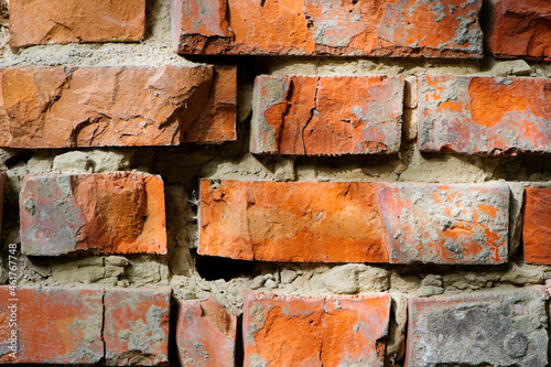 red old brick wall background, brick wall texture, structure. old broken brick, cement joints, close-up. crumbling from old age. macro photo. construction, repair. concept of devastation, decline