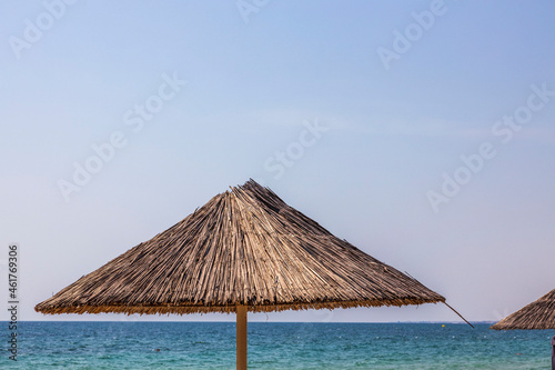Fototapeta Naklejka Na Ścianę i Meble -  Beautiful view of white sand beach with sun umbrella and sunbed. Greece.