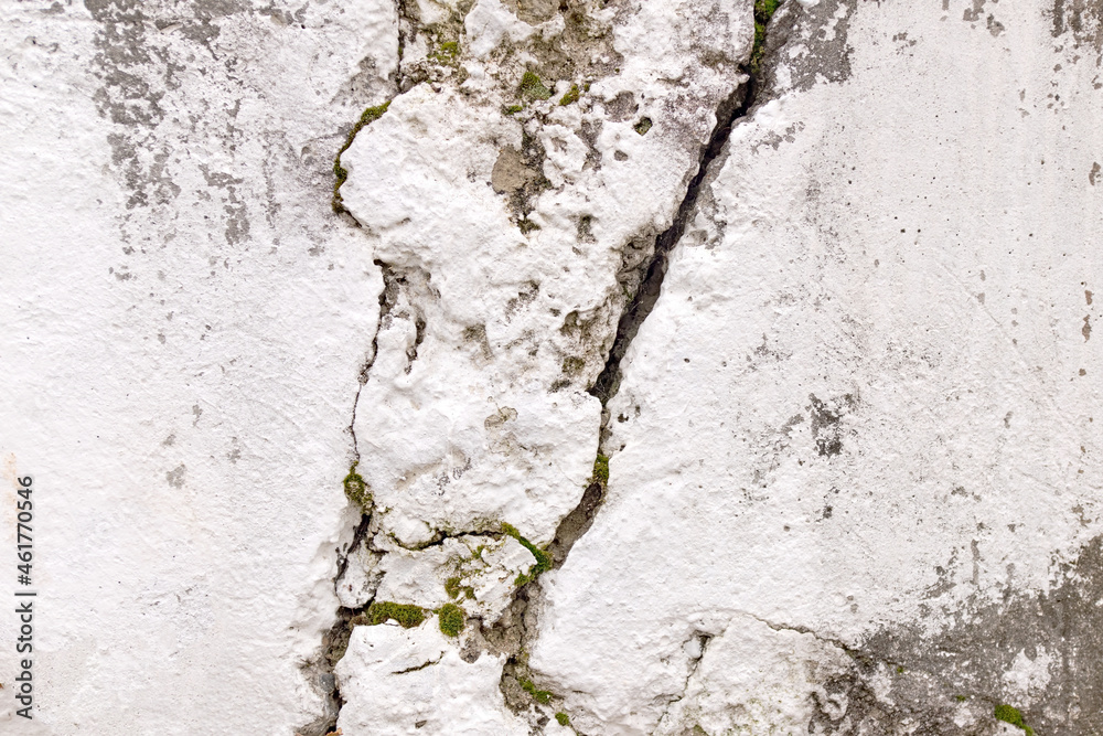 Cracked concrete wall covered with white paint  surface as background images