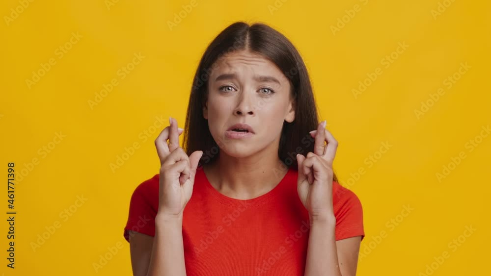 Millennial Woman Keeping Fingers Crossed For Luck Over Yellow Background Millennial Woman Keeping Fingers Crossed For Luck Over Yellow Background