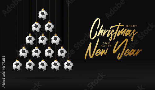 soccer Christmas and new year greeting card bauble tree. Creative Xmas tree made by football ball on black background for Christmas and New Year celebration. Sport greeting card