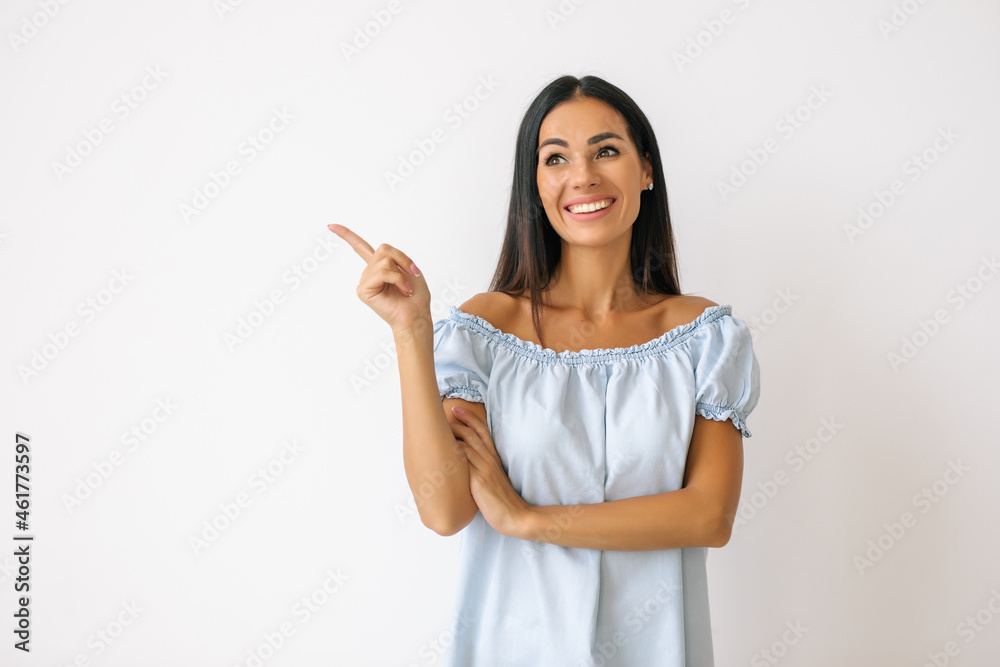 Happy woman pointing to the side isolated over a white background Happy woman pointing to the side isolated over a white background