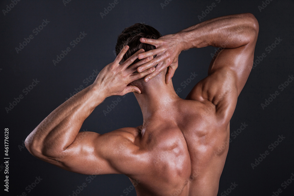 Muscular shoulder and back area of a man. Shot in studio.