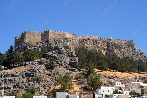 The ancient acropolis of Lindos and the modern city at the foot of the cliff. Rhodes Island. Greece. Place for text.