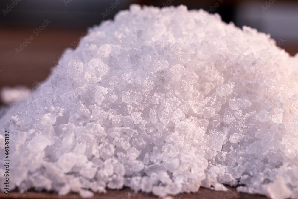 A close-up macro shot of a handful of coarse salt. A close-up macro shot of a handful of coarse salt.