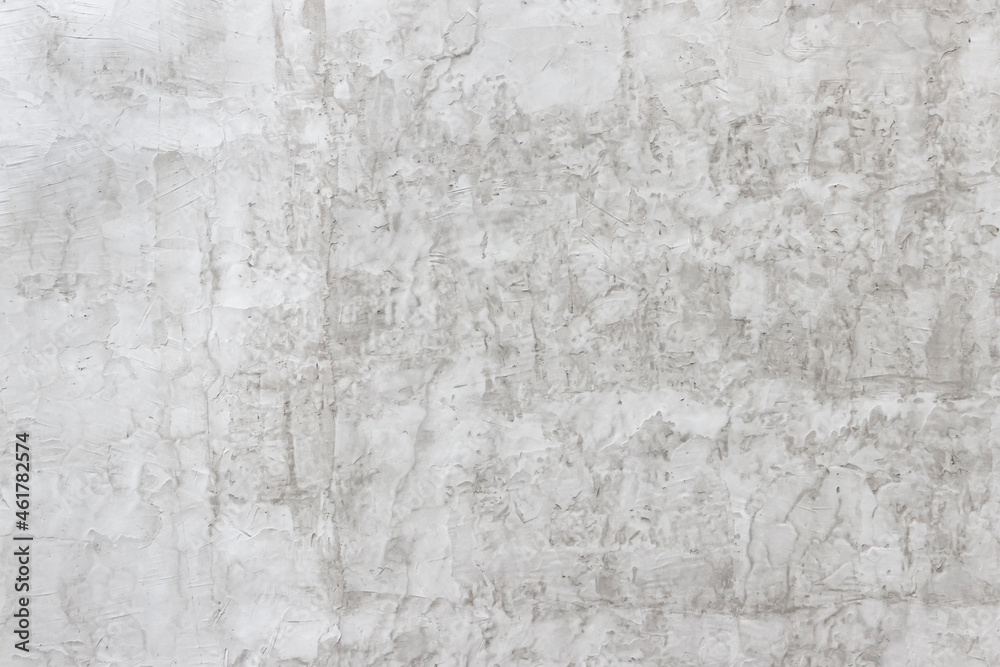 Shabby wall of an old house with uneven crumbling plaster. Yellow-gray abstract texture. Shabby wall of an old house with uneven crumbling plaster. Yellow-gray abstract texture.