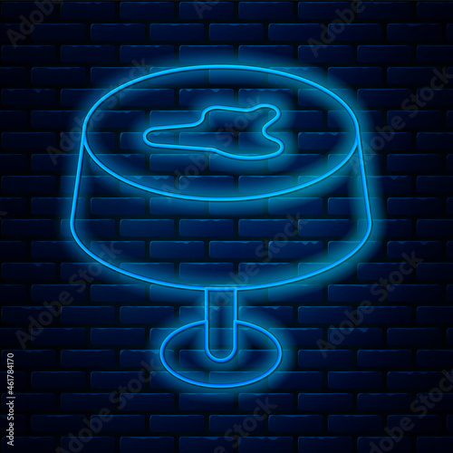 Glowing neon line Stain on the tablecloth icon isolated on brick wall background. Vector