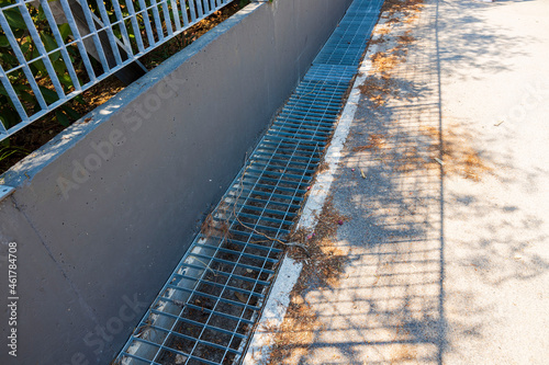 Technology view of outdoor sewer grate for water drainage isolated. Greece.
