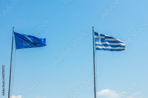 Beautiful view of Greece and Europe flags on blue sky background. Greece. 